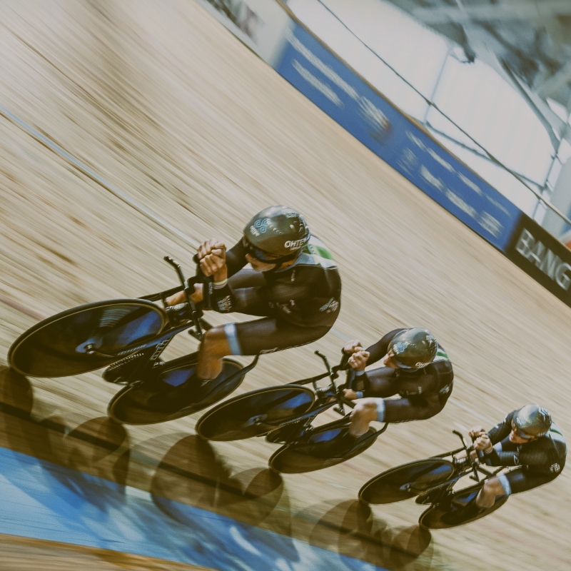 Richard Oakes leading a team time trial team at the world masters championships on a velodrome.